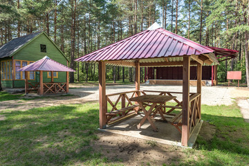 wooden camping arbors  with all conviniences in a pine forest
