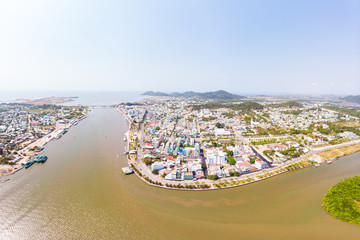 Aerial view Ha Tien city skyline from above, Mekong river delta, South Vietnam. Famous tourism destination ferry to Phu Quoc island. Clear blue sky.