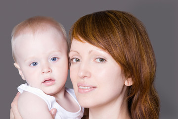 Portrait of mid adult woman with her cute little daughter 