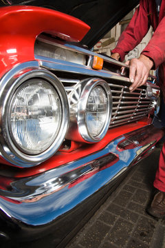 Mechnic In Red Boiler Suit Fixing Classic Car