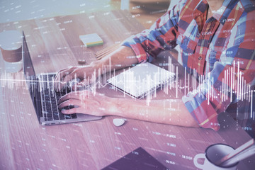 Multi exposure of forex graph with man working on computer on background. Concept of market analysis.