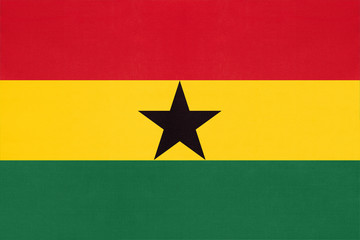 Republic of Ghana national fabric flag, textile background. Symbol of world African country.