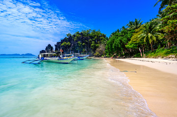 Tropical Papaya beach at paradise coast, El Nido, Palawan, Philippines. Tour A Route. Coral reef and sharp limestone cliffs.