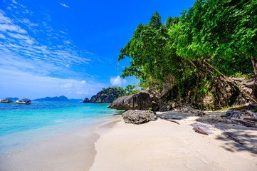 Tropical Papaya beach at paradise coast, El Nido, Palawan, Philippines. Tour A Route. Coral reef and sharp limestone cliffs.