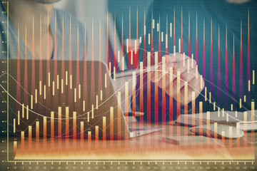 Forex graph with businessman typing on computer in office on background. Concept of analysis. Double exposure.