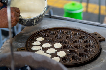 Selective focus on Khanom Khai (Thai oval sweetmeat made with egg and sugar)
