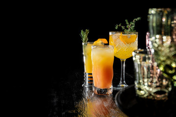 Three alcoholic cocktail with juice garnished gin, apricot brandy and orange juice.