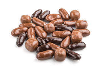 Pile of dark and milk chocolate candies isolated on white background. close up, side view.