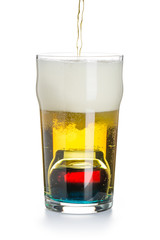 Depth charge cocktail of beer, liqueur and vodka, prepared by mixing a submerged inverted Cup at the bottom of a beer glass isolated on white. The process of creating a cocktail