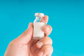 Hand holding medication vial mock up.