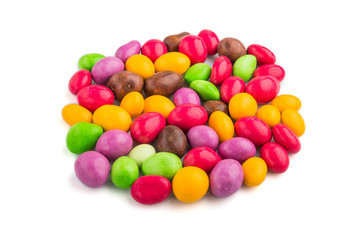 Pile of multicolored chocolate candies isolated on white background. close up, side view.