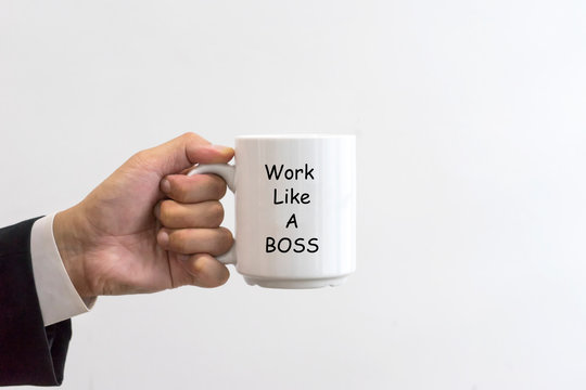 Businessman Holding A White Mug With Text Work Like A Boss.