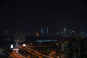 Fototapeta na wymiar Night view of Kuala Lumpur city with busy traffic jam on the highway.;