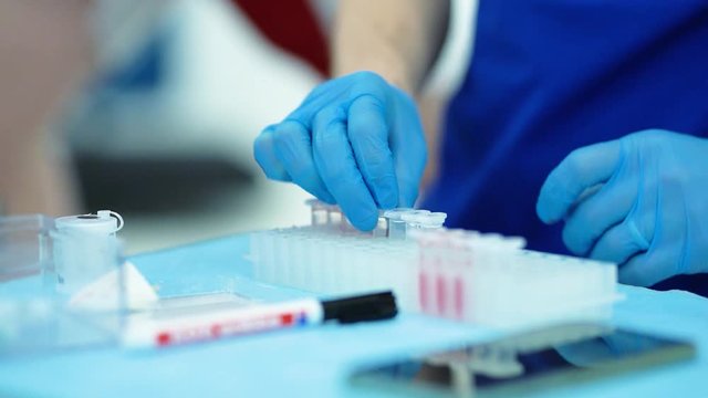 Professional sport science research blood test in modern lab. scientist and athlete during the testing sport medicine laboratory technology