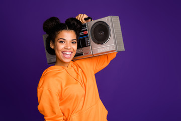 Close-up portrait of her she nice attractive funky cool cheerful cheery brunette girl in hoody carrying boom box isolated over bright vivid shine vibrant lilac violet purple color background © deagreez