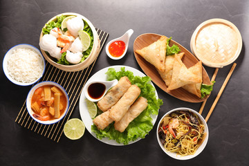 assorted of asian food- spring roll, noodles soup, dim sum, fried noodles