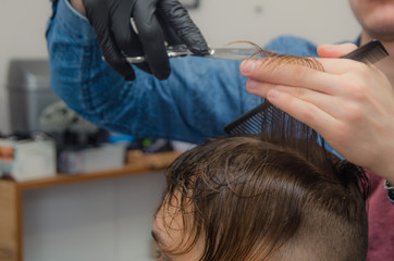 Fototapeta premium male haircut on a white background. Male hairdresser.