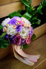 Close up of engagement rings on the roses bouquet.