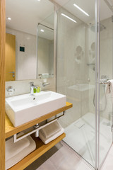 Interior of a luxury hotel bathroom with glass shower cabin