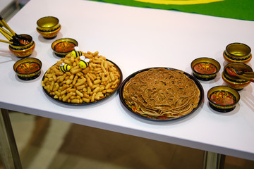 Russian cuisine-pancakes with honey on large national plates