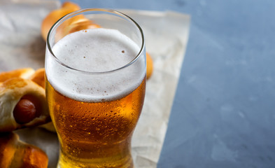 Cold glass of beer close-up and snack sausages copy space