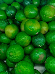 lots of green ripe lime citrus for eating like a background