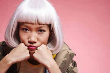 Image of asian girl propping up her head and looking at camera