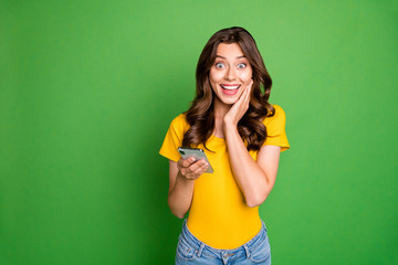 Portrait of her she nice attractive lovely charming cheerful cheery wavy-haired girl using 5g app fast speed internet online isolated over bright vivid shine vibrant green color background