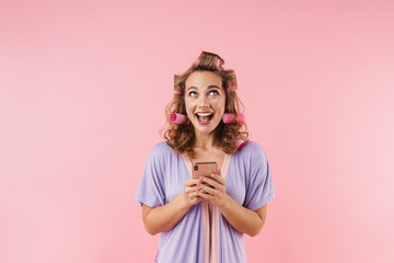 Image of young happy woman smiling and using cellphone