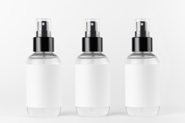 Three transparent spray bottles for cosmetics product with white blank label on white background, mock up for branding, advertising, presentation, design.