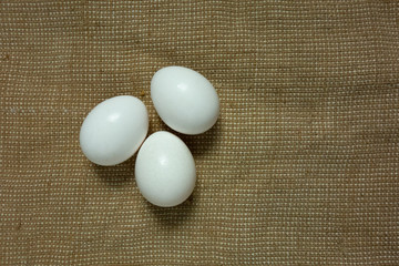 Eggs on bagging fabric closeup view. Easter background with copy space. Traditional farming healthy food product. Protein nutrition source
