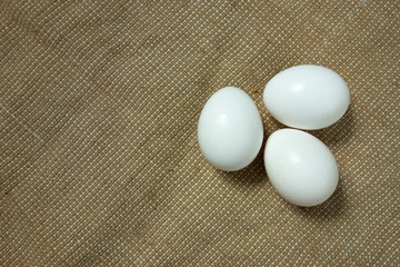 Eggs on bagging fabric closeup view. Easter background with copy space. Traditional farming healthy food product. Protein nutrition source