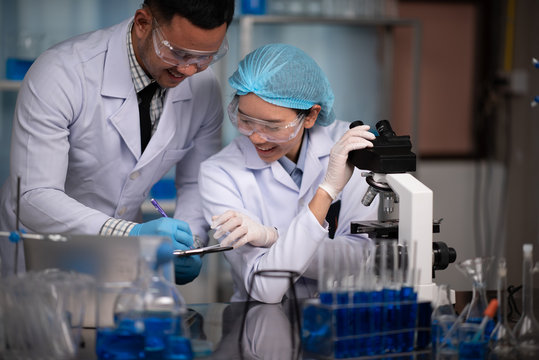 Scientific researchers team are working in the laboratory - Powered by Adobe