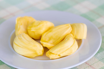 Juicy ripe jackfruit slices on a white plate. Jackfruit is high in a few powerful antioxidants that provide various health benefits. (Exotic tropical fruit) 