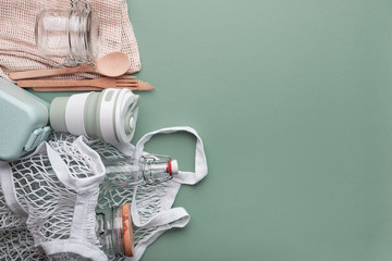 Zero waste grocery shopping concept. Cotton bags, reusable cup, glass bottles and jar. Top view, copyspace