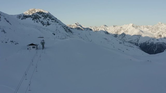 Drone shot showing the cable wires on a T-Bar lift in Soelden together with Passo del rombo.