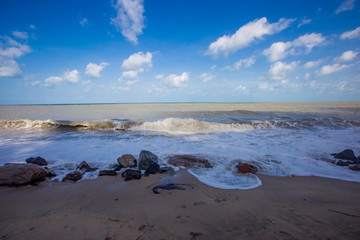 The blurred natural background of the blue sky by the large lake, with the sea rolling over the beach all the time, can be seen during the summer season.
