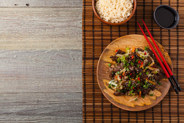 Traditional Korean Bulgogi dish.  Thinly cut, grilled beef, served with rice and vegetables.