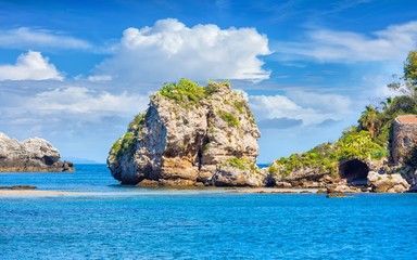 Naklejka premium Big rock and narrow path connecting Isola Bella island to mainland Taormina beach, Sicily, Italy.