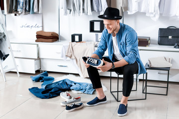 Handsome man choosing shoes in dressing room