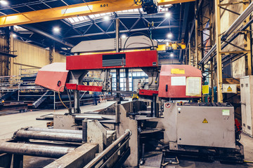 Fototapeta na wymiar Saw machine for cutting steel profiles in a factory,