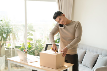 Man opening fragile parcel ordered from internet