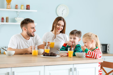 Happy family having lunch in kitchen