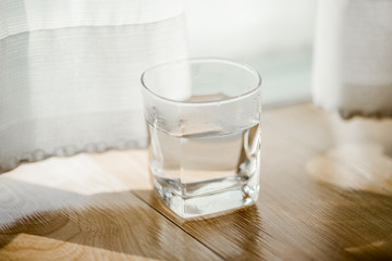 Close-up view of the blue coffee mug, clear glass for drinking water, placed on a tray to bring clear drinks, seen at resorts, hotels or bakeries
