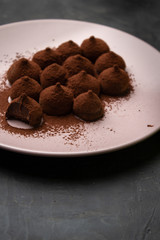 Chocolate truffles in dark background with copy space.