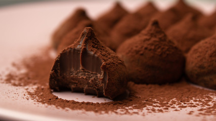 Chocolate truffles in dark background with copy space.