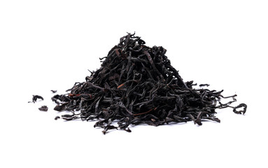 Pile of black tea leaves scattered on white table