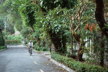 Fototapeta na wymiar Asian young man ride road bikes on the road in the morning
