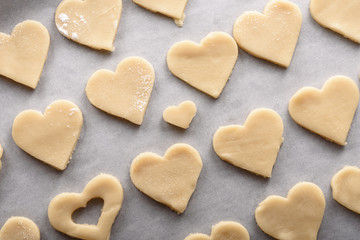 Fototapeta na wymiar uncooked cookies hearts on parchment paper