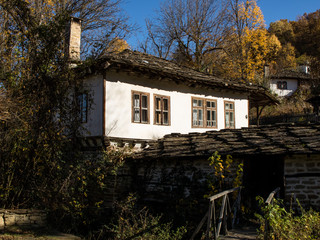 Fototapeta na wymiar Traditional Bulgarian old houses in Bozhentsi village, Bulgaria, Gabrovo. А beautiful village in the fall. Аutumn walk in a mountain village. Autumn forest for background